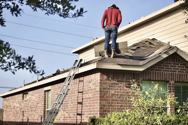 Professional roofer working on a residential roof in Franklin Forge
